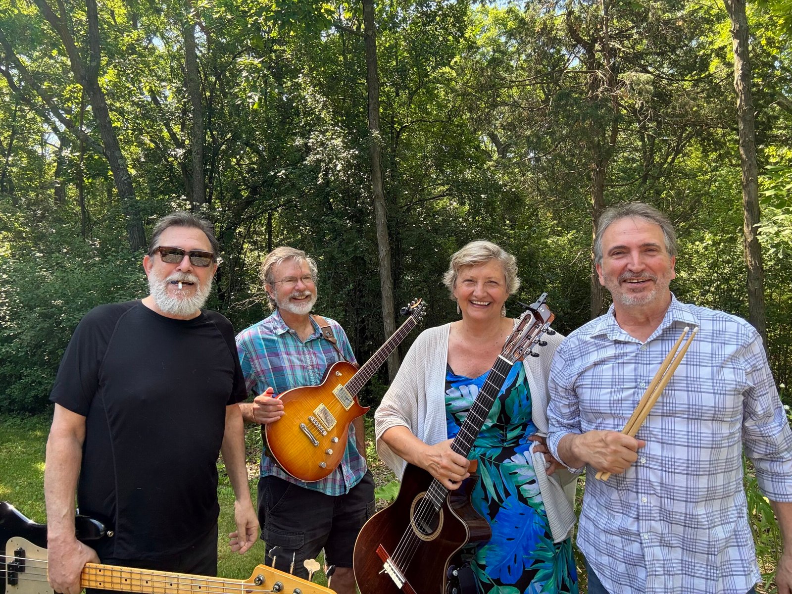 The Martha Bache-Wiig Quartet shown standing together with the forest as a background
